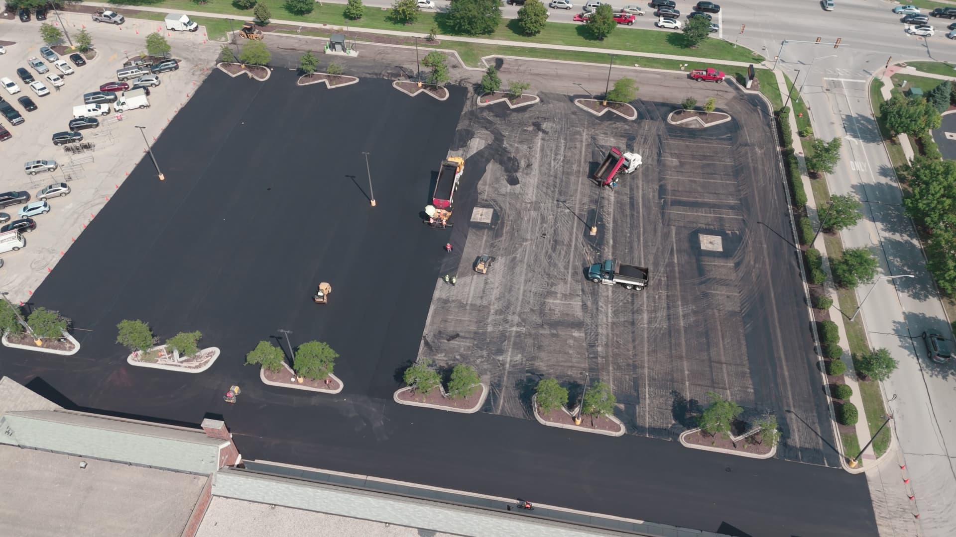 Aerial view of crews asphalt paving a commercial parking lot in Dallas–Fort Worth, TX — Blackland Asphalt